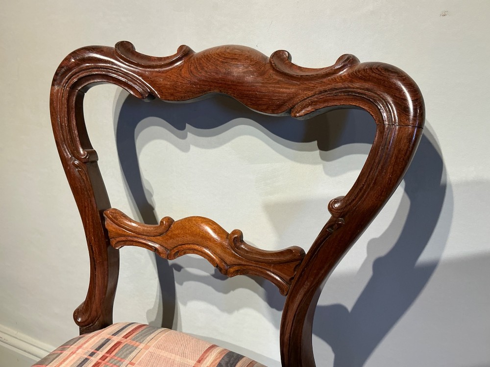 A set of six early Victorian balloon back dining chairs crafted from dark polished wood with striped upholstery. View VII