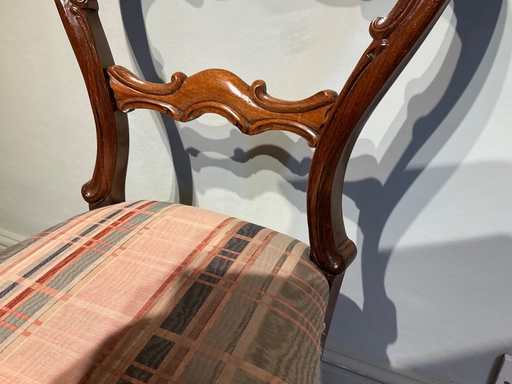 A set of six early Victorian balloon back dining chairs crafted from dark polished wood with striped upholstery. View VIII