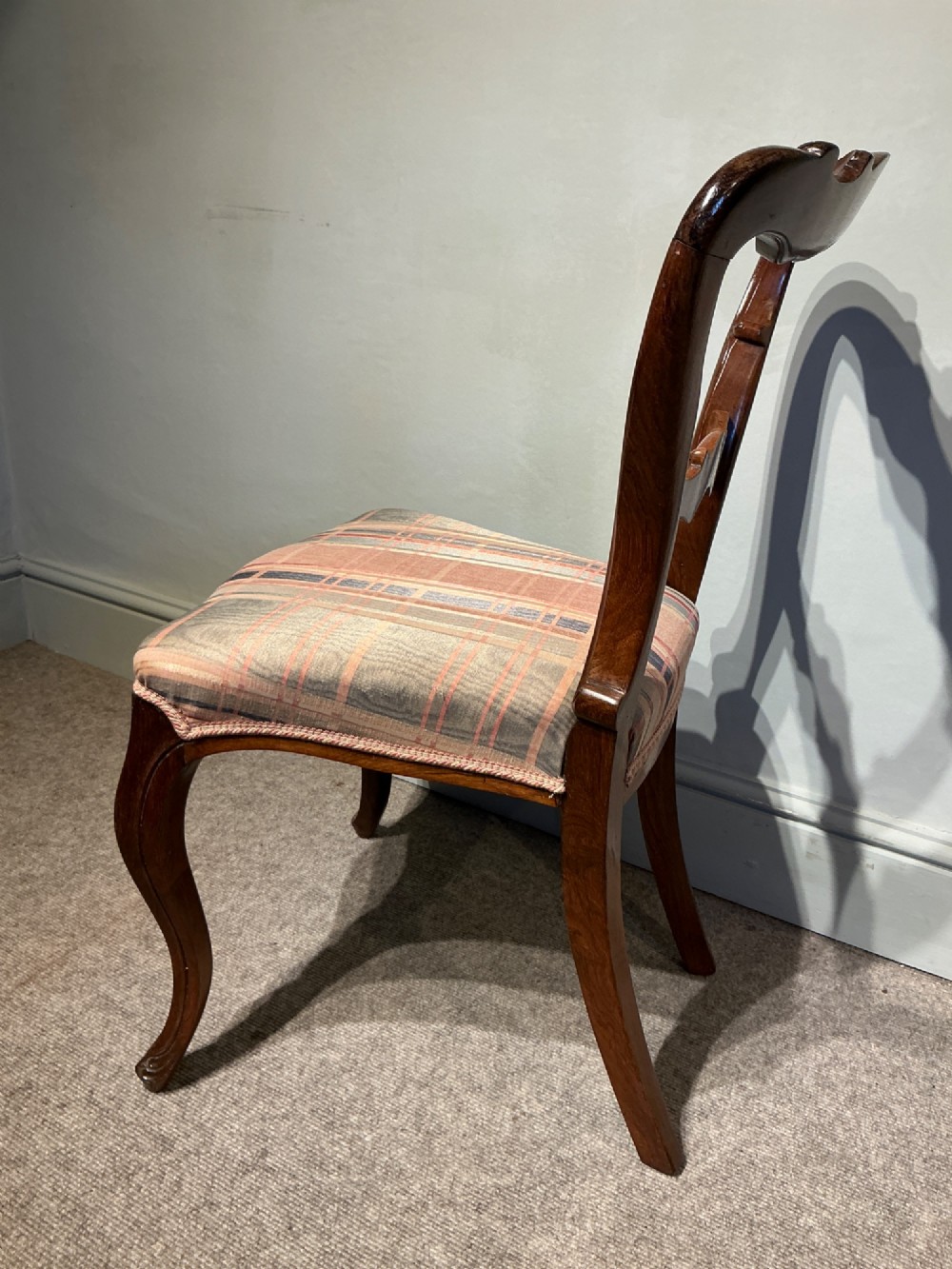 A set of six early Victorian balloon back dining chairs crafted from dark polished wood with striped upholstery. View IX