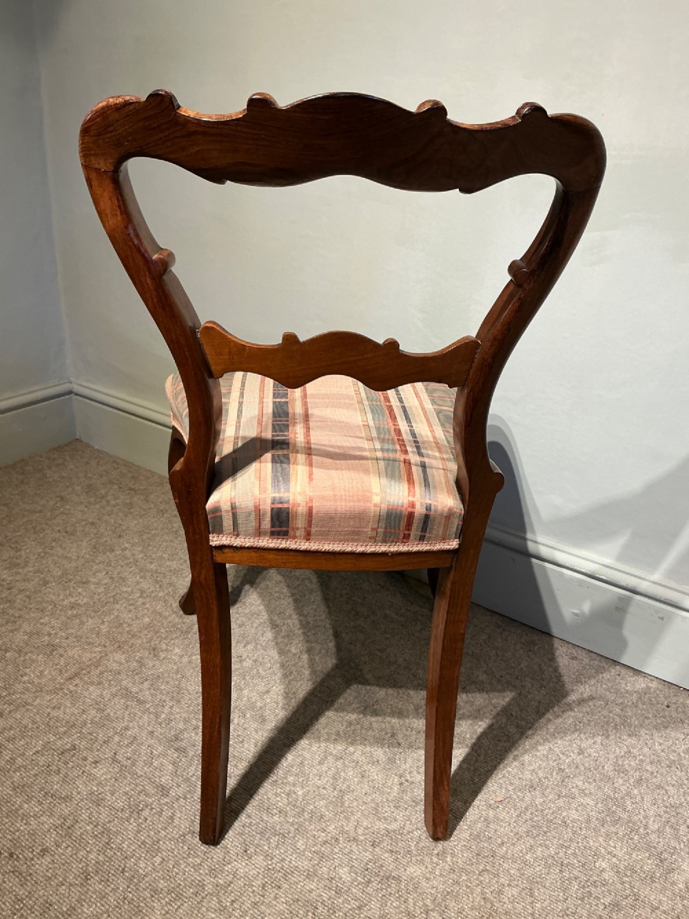 A set of six early Victorian balloon back dining chairs crafted from dark polished wood with striped upholstery. View X