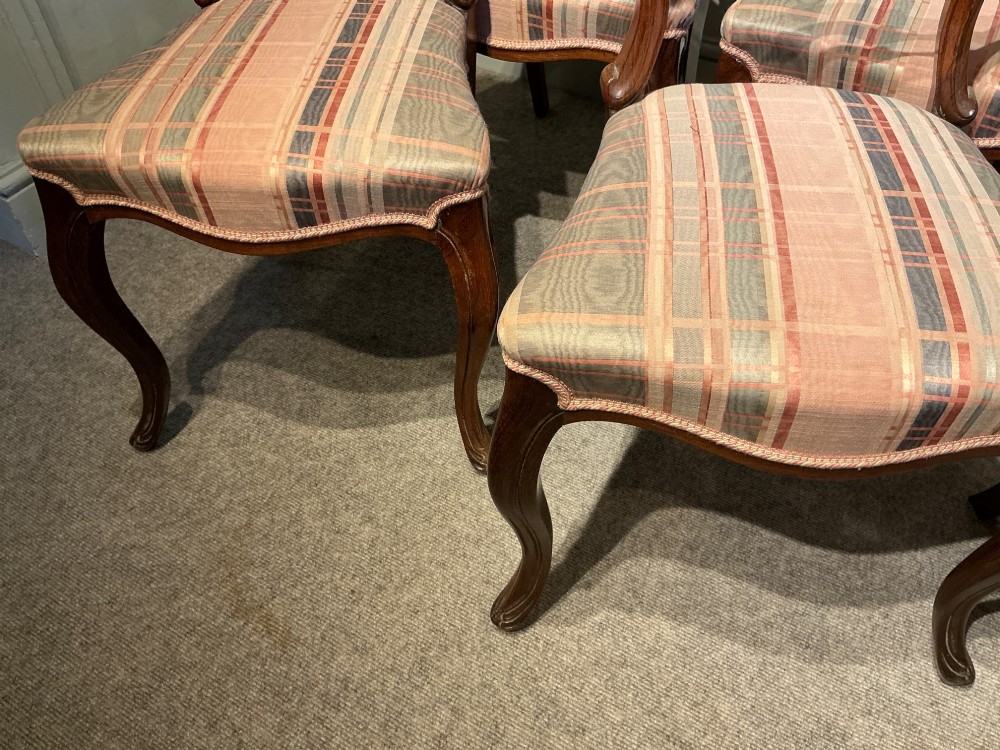 A set of six early Victorian balloon back dining chairs crafted from dark polished wood with striped upholstery. View XI
