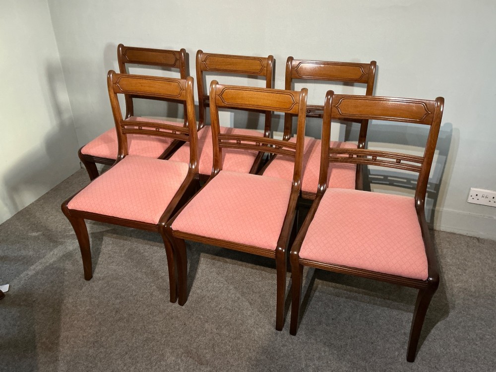 A set of six Regency mahogany dining chairs featuring tablet top rails, beaded crossbars, and rose-pink upholstered drop-in seats. View II