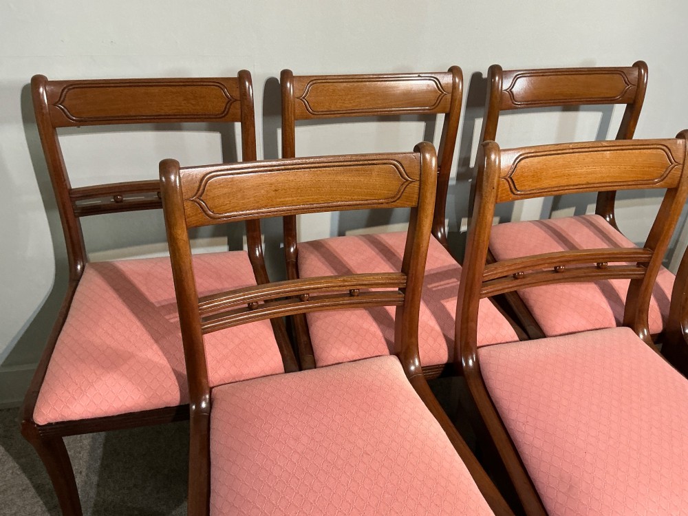 A set of six Regency mahogany dining chairs featuring tablet top rails, beaded crossbars, and rose-pink upholstered drop-in seats. View IV