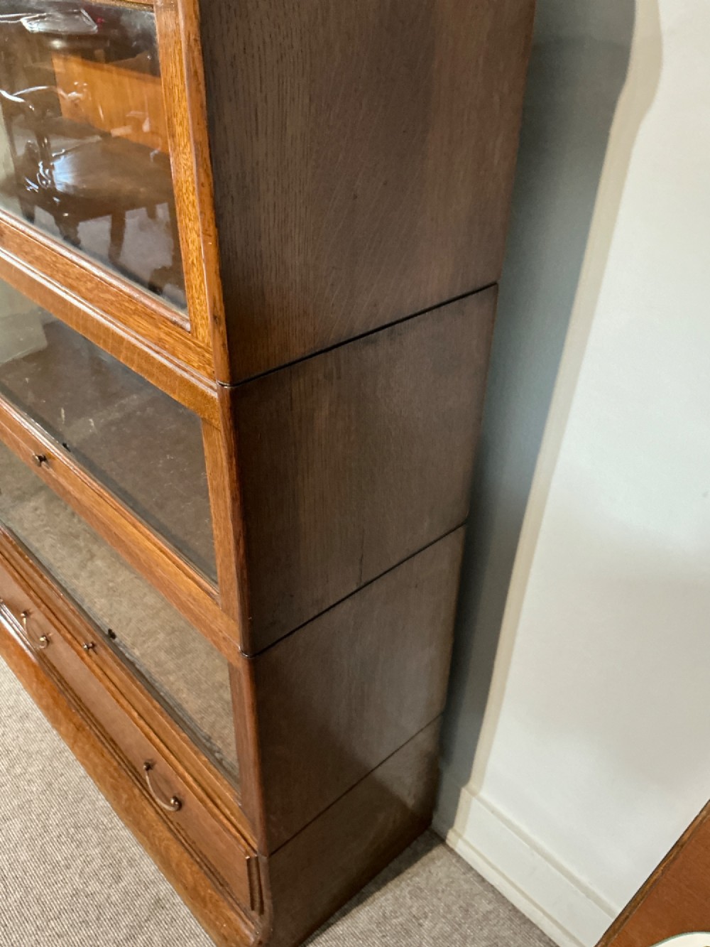 A 1920s oak three-tier sectional bookcase featuring glazed lift-up doors and a single drawer at the base. View IX