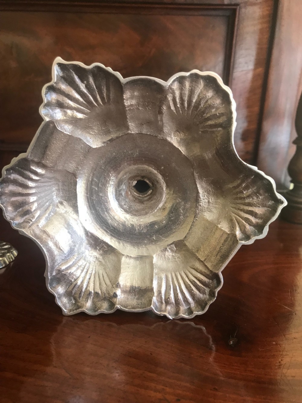 A set of four 18th-century sterling silver candlesticks with scalloped shell-moulded bases and cast baluster stems. View II