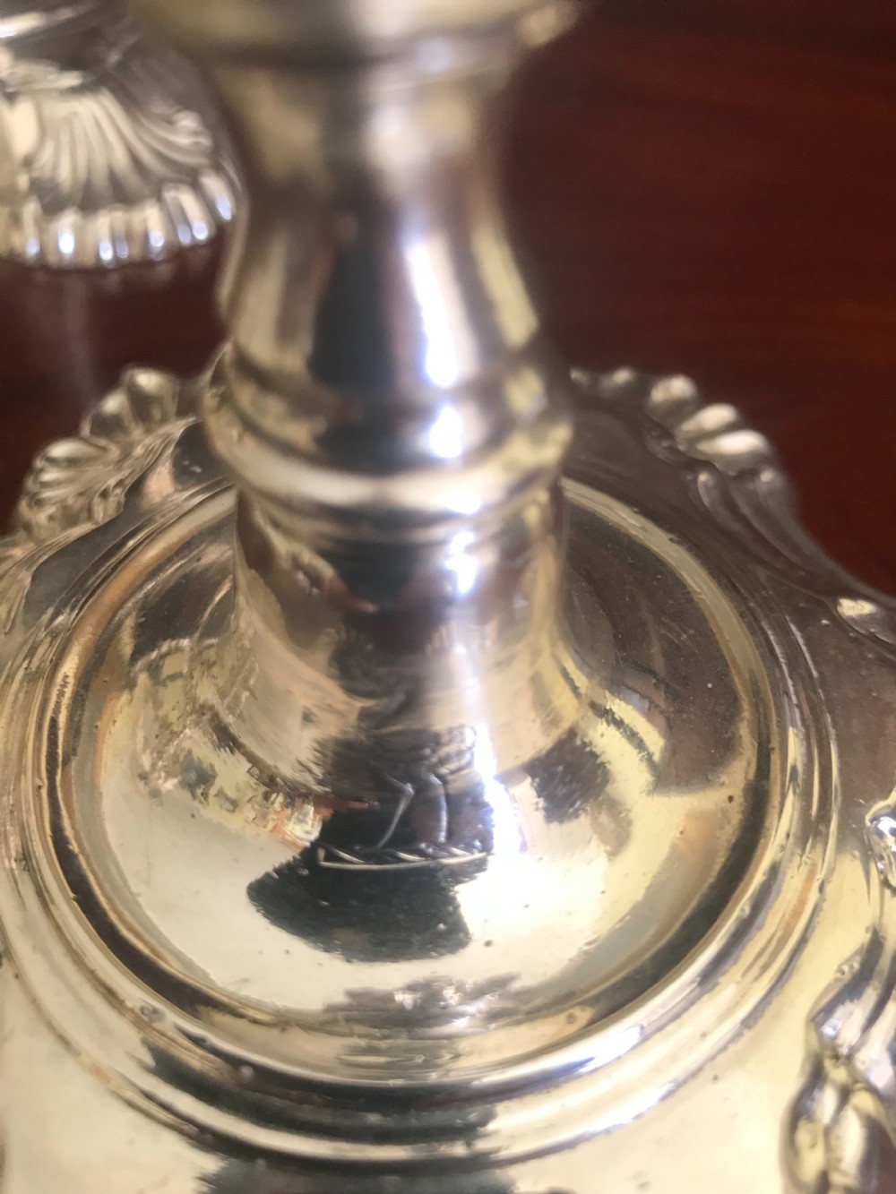 A set of four 18th-century sterling silver candlesticks with scalloped shell-moulded bases and cast baluster stems. View IV