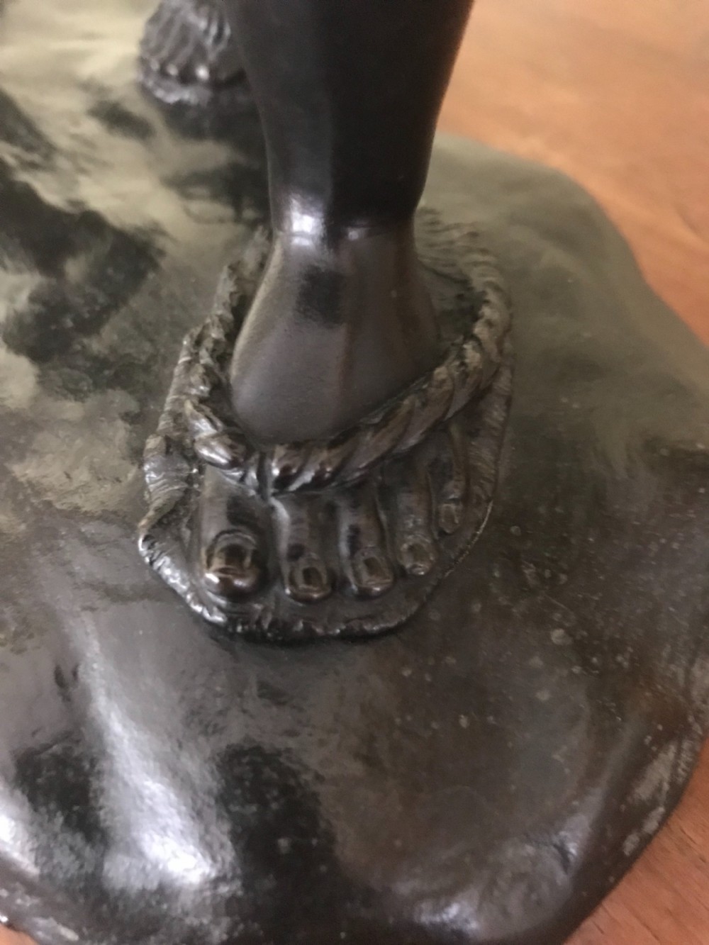 A dark bronze Japanese okimono sculpture depicting a boy in traditional kimono and geta sandals walking beside a chicken on a cast naturalistic base. View VII