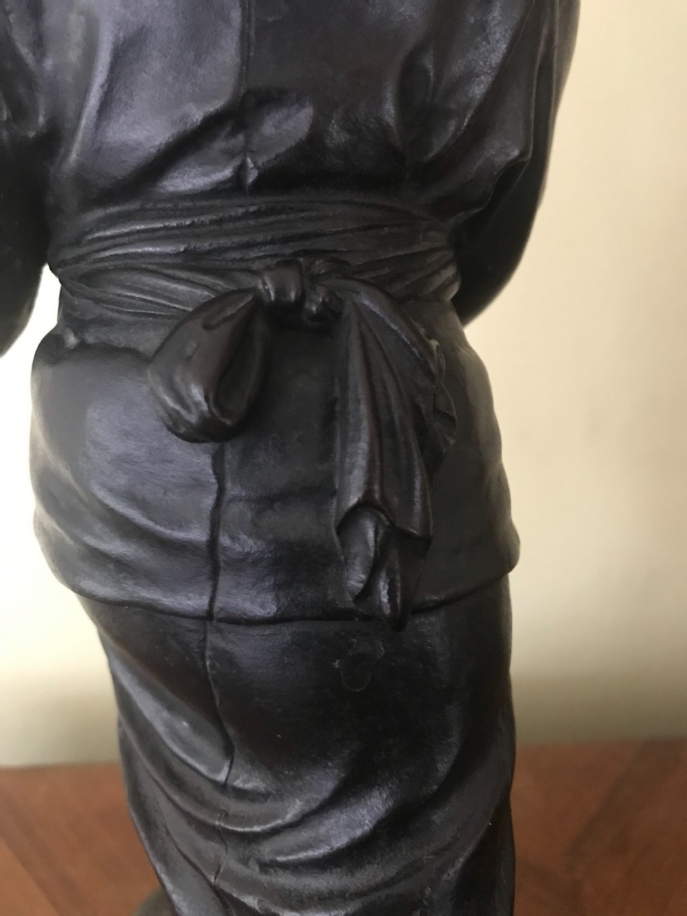 A dark bronze Japanese okimono sculpture depicting a boy in traditional kimono and geta sandals walking beside a chicken on a cast naturalistic base. View VIII
