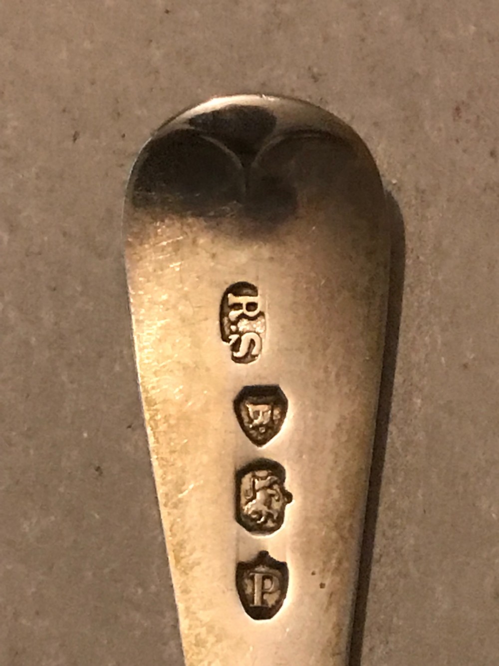 A cased set of twelve sterling silver teaspoons with bright-cut engraved stems alongside matching sugar tongs in a crimson velvet presentation box. View III
