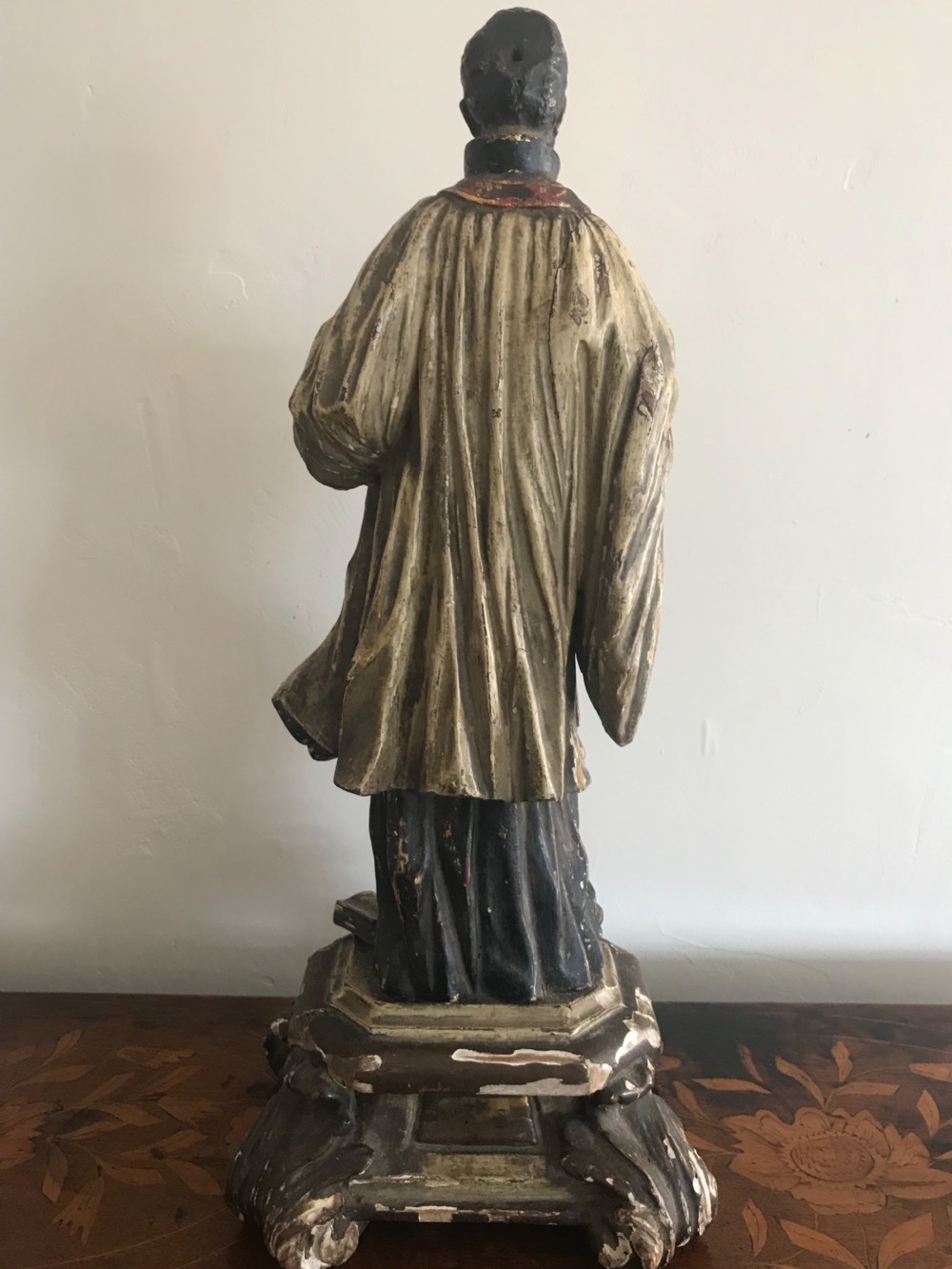A late 18th-century polychromed wood carving depicting a standing bearded saint holding an infant, set upon a carved pedestal base. View III