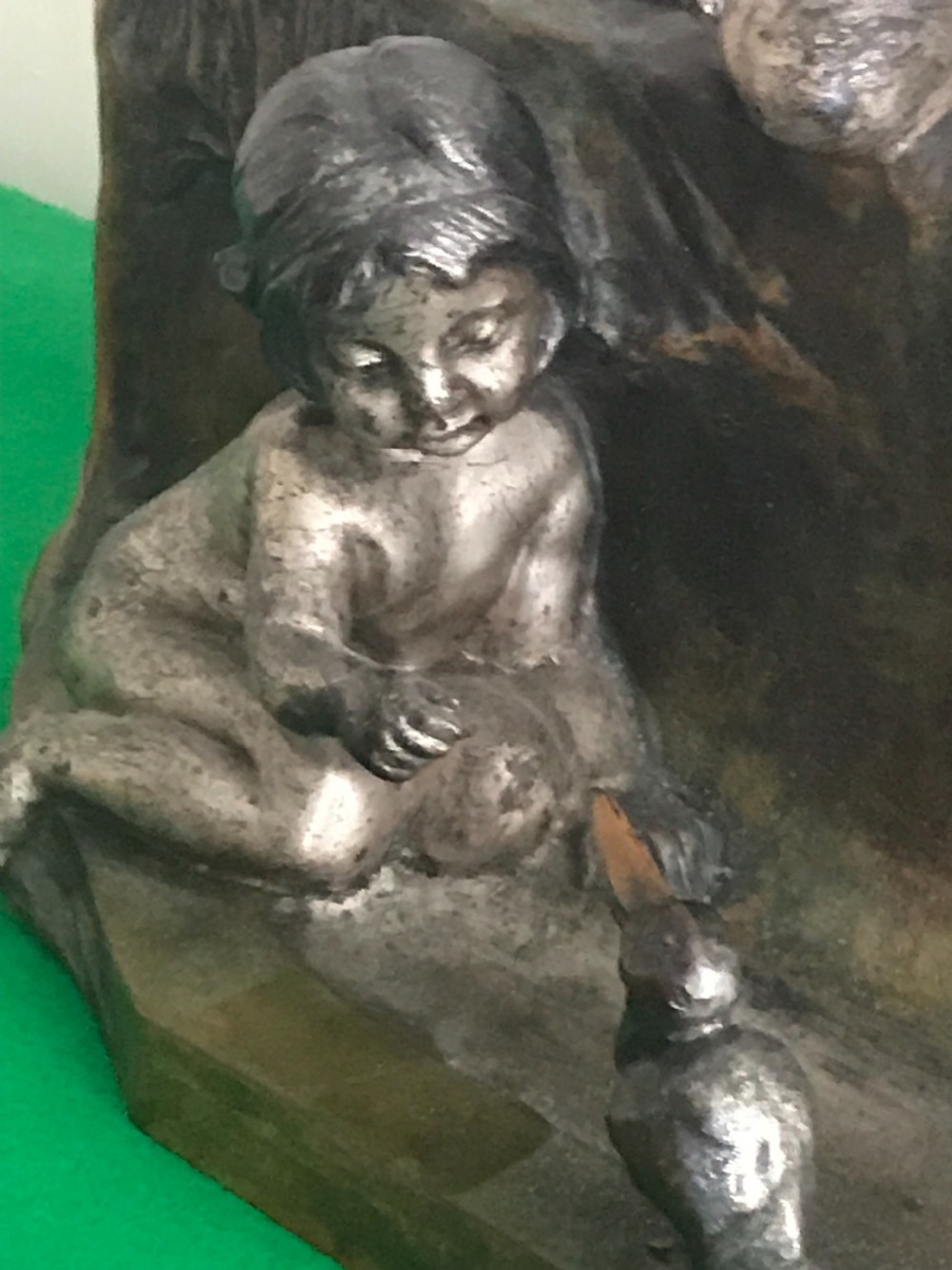 An antique patinated and silvered bronze sculpture depicting three children playing near a stream with a family of ducks, signed by Antoine Bofill. View V