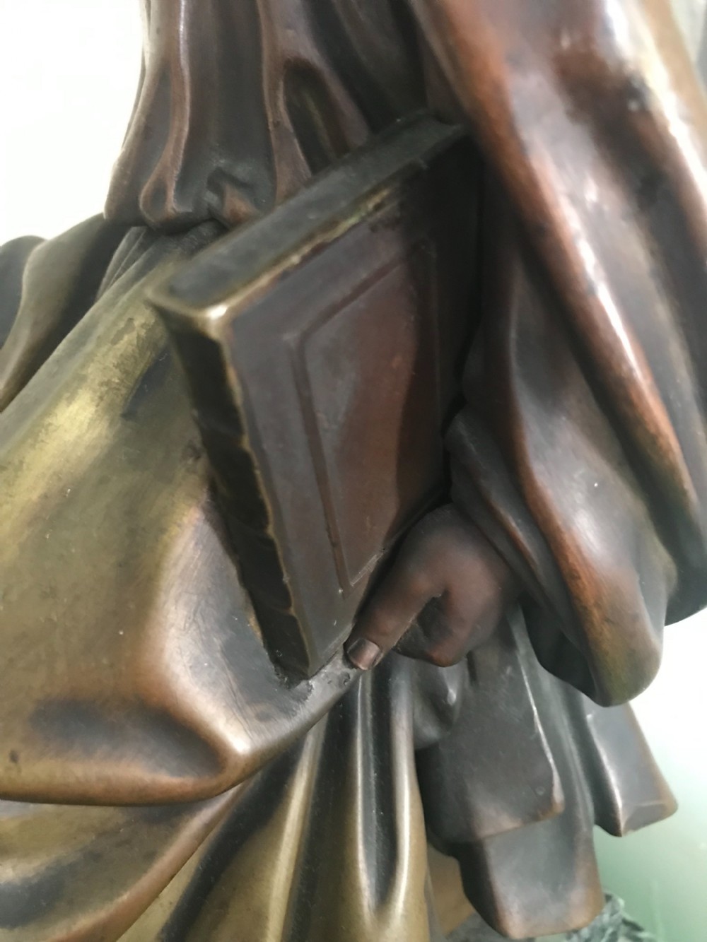 A patinated dark bronze sculpture depicting a draped, bearded ancient scholar seated on a green veined marble base. View III