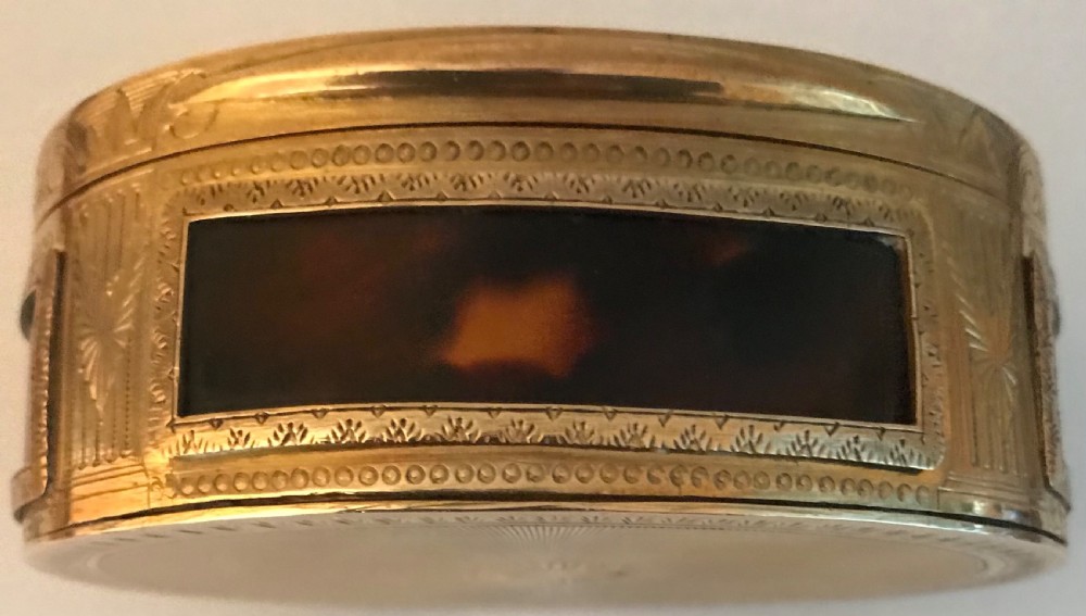 An oval gilt brass table snuff box featuring an inlaid mother-of-pearl lid panel depicting a chariot driven by horses. View III