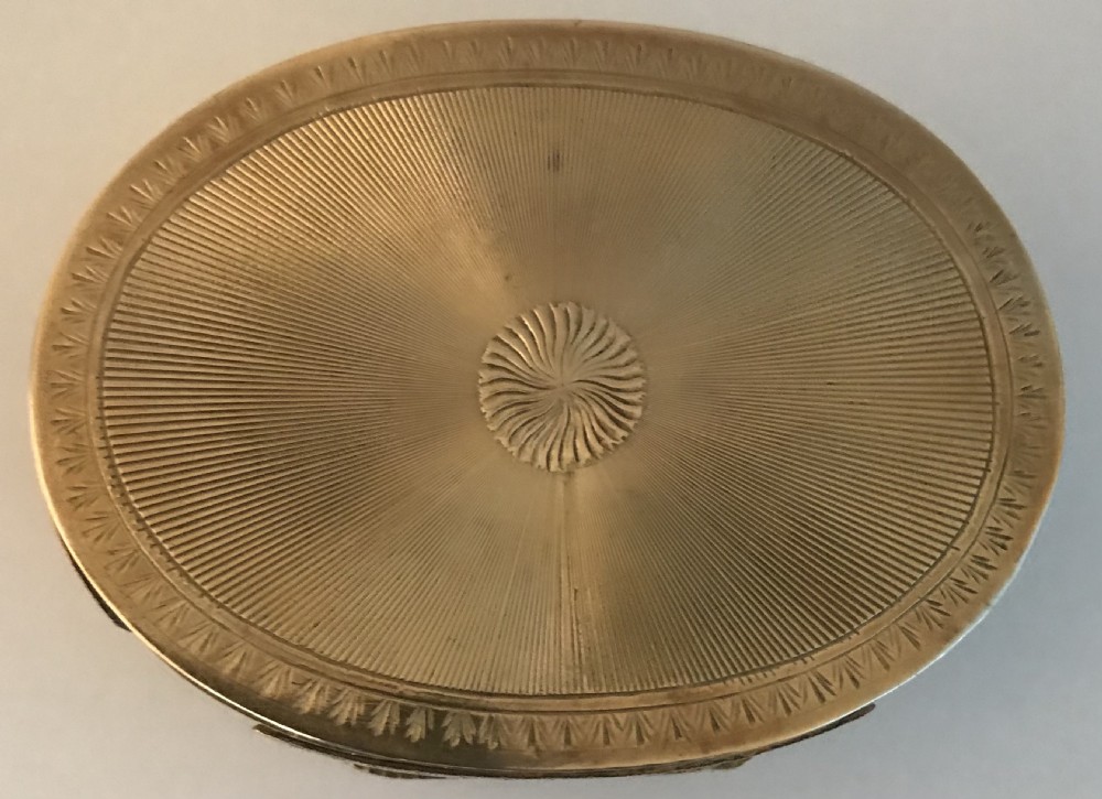 An oval gilt brass table snuff box featuring an inlaid mother-of-pearl lid panel depicting a chariot driven by horses. View IV