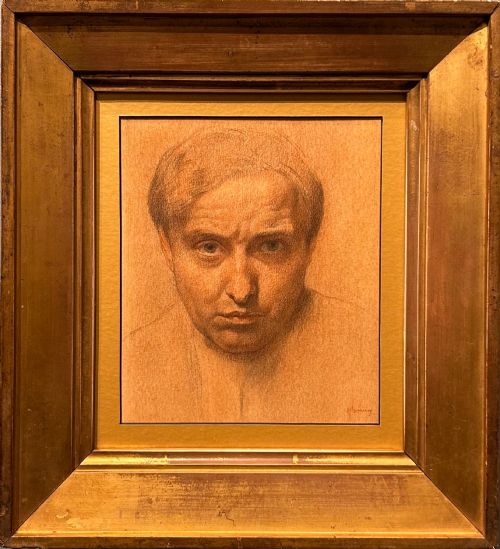 fig 1. A monochrome warm brown chalk and charcoal self-portrait study depicting a mans face looking directly forward on textured paper.