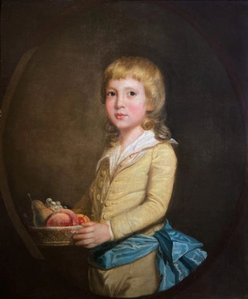 fig 1. An 18th-century oil painting depicting a young boy in a yellow jacket and blue sash holding a fruit basket, set within a carved gilded wooden frame.