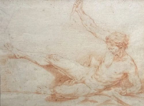 fig 1. An eighteenth-century red chalk drawing of a reclining male figure mounted on a grey mat and housed in a gilded frame.