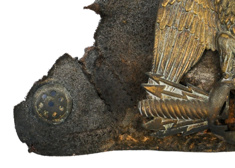 A framed shadow box displaying a stamped brass Napoleonic imperial eagle shako plate bearing the number 42 mounted on a distressed dark leather hat fragment. View V