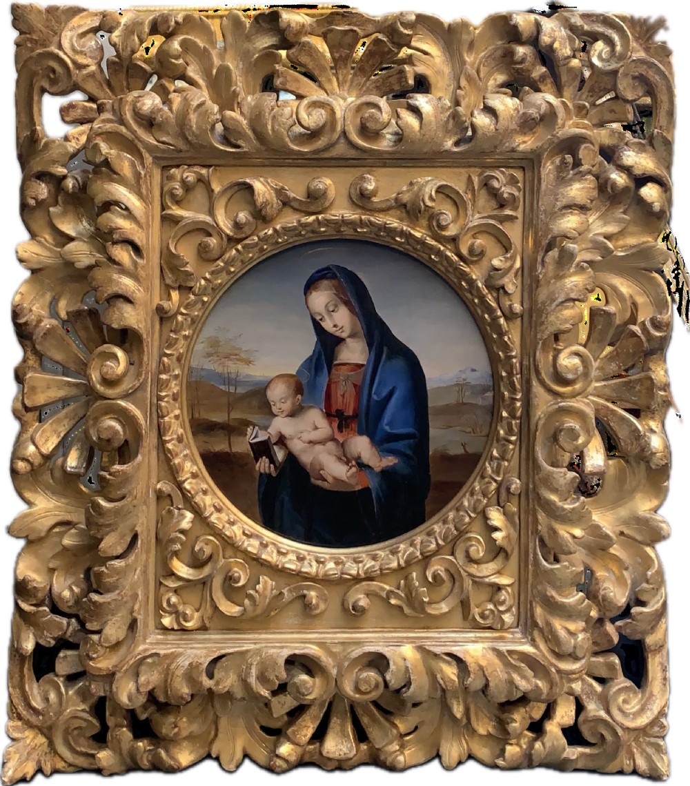A circular oil painting depicting the Virgin Mary in a blue cloak holding the Christ Child, enclosed within an ornate rectangular carved giltwood frame.