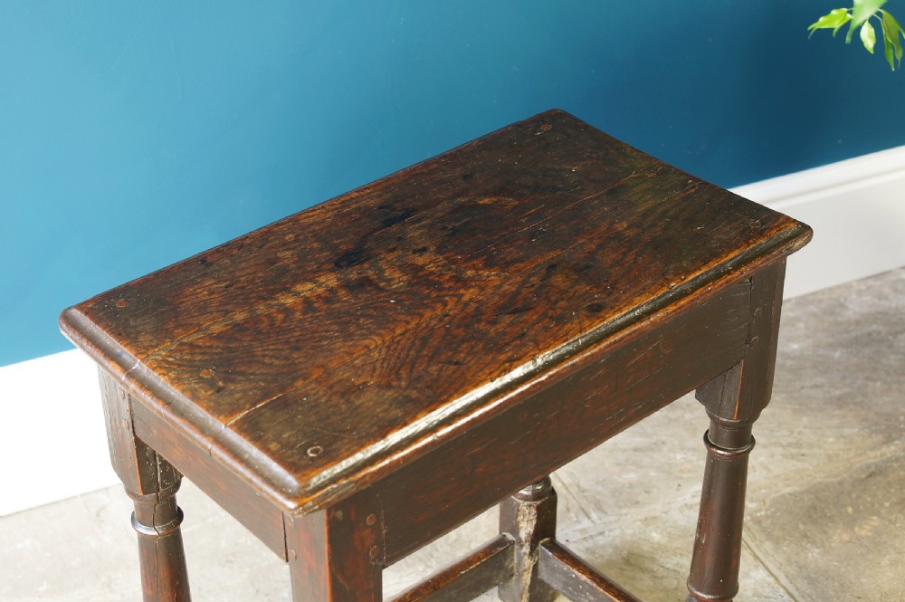 A 17th Century Oak and Fruitwood joint stool View V