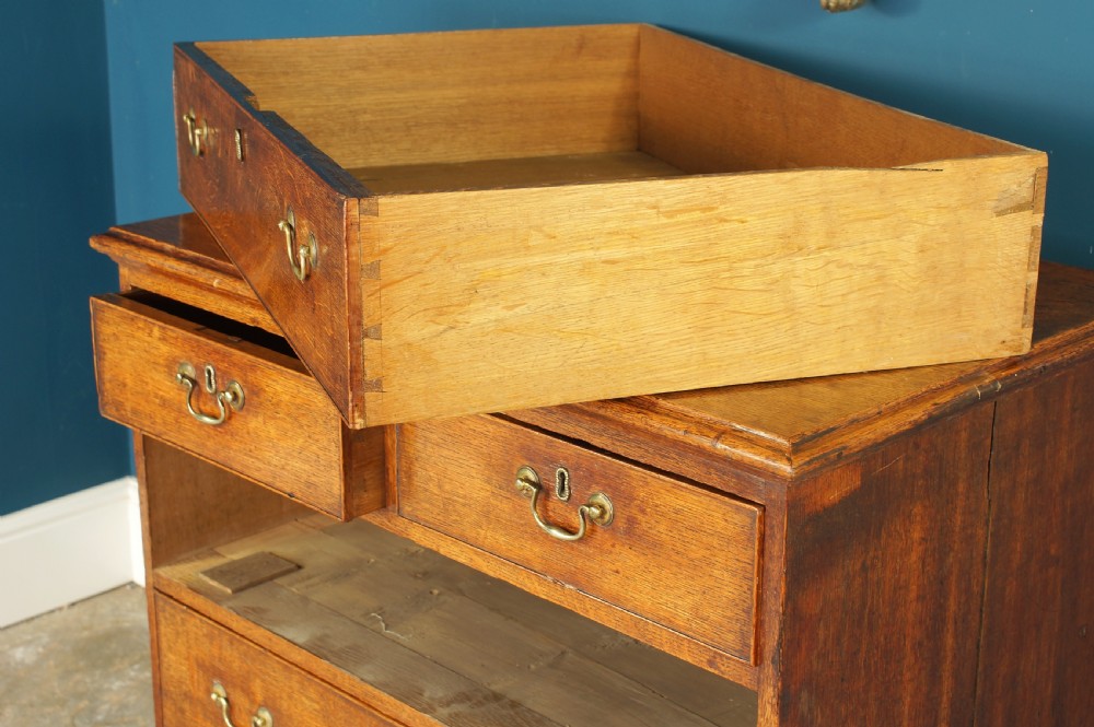 A small Georgian Oak chest of drawers. View XI