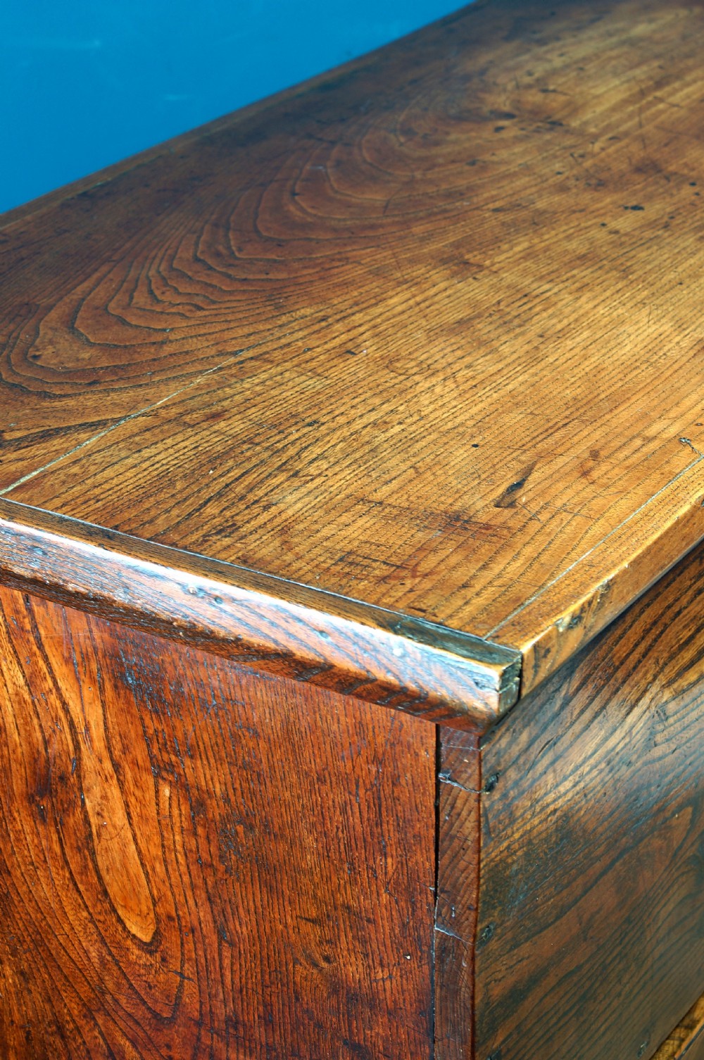 A Georgian elm mule chest featuring a hinged top lid over two wide drawers with brass swan-neck handles. View XI