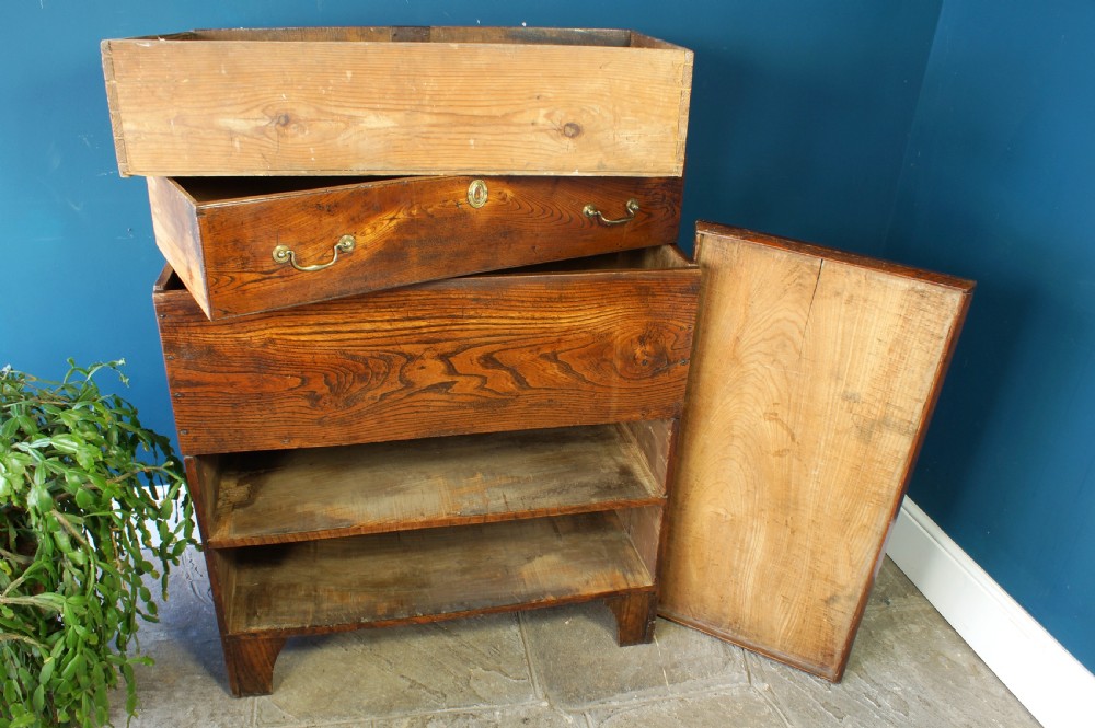 A Georgian elm mule chest featuring a hinged top lid over two wide drawers with brass swan-neck handles. View XIV