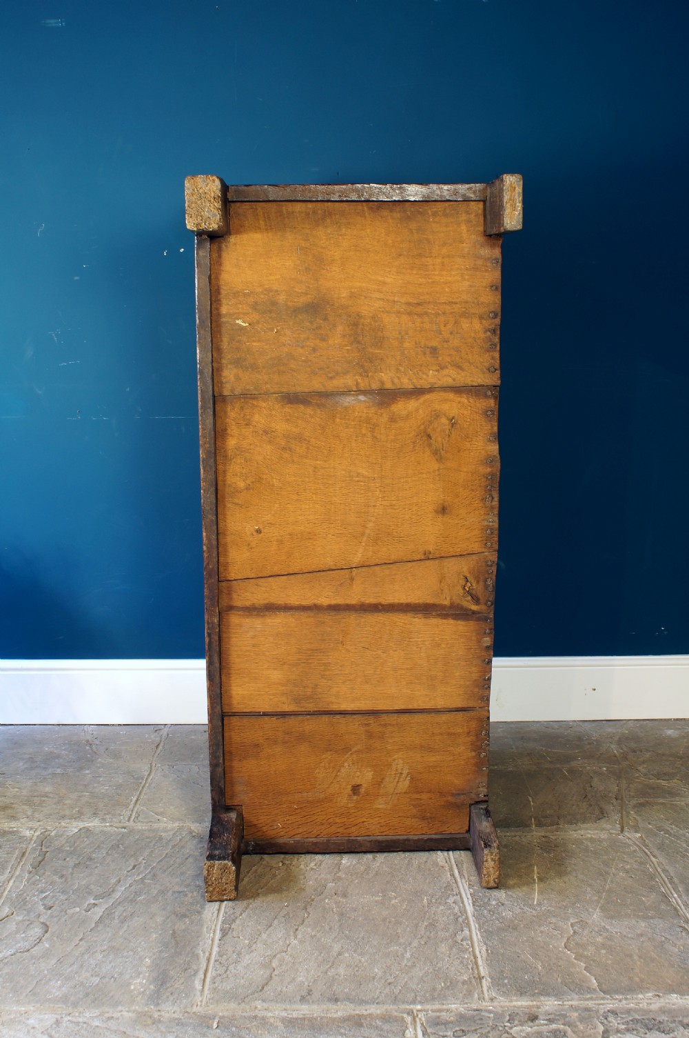 A 17th-century dark oak coffer with a carved geometric frieze, panelled front, and three-panel top lid. View XIV