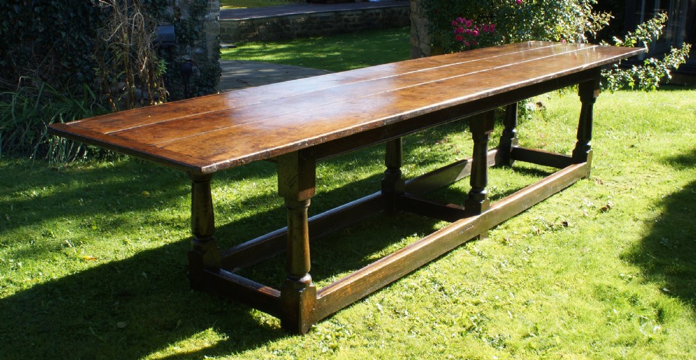 A large 17th-century oak refectory dining table with a long plank top, six turned legs, and robust perimeter stretchers. View XIII