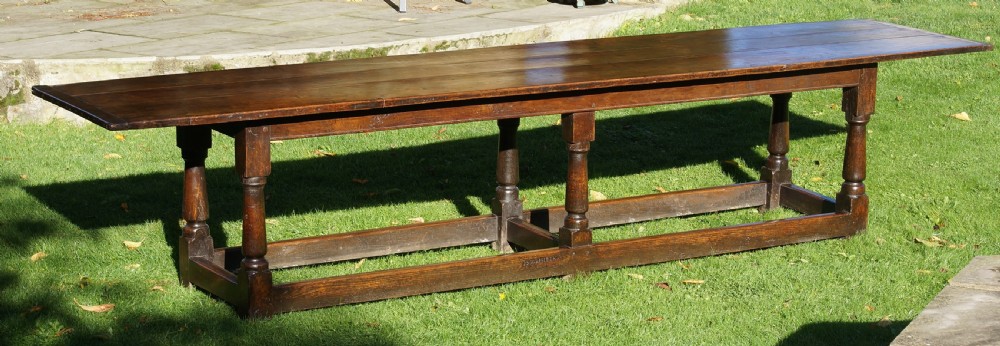 A large 17th-century oak refectory dining table with a long plank top, six turned legs, and robust perimeter stretchers. View II