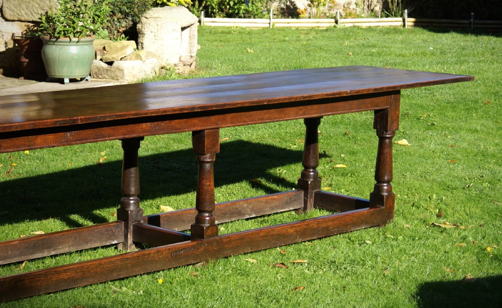 A large 17th-century oak refectory dining table with a long plank top, six turned legs, and robust perimeter stretchers. View III