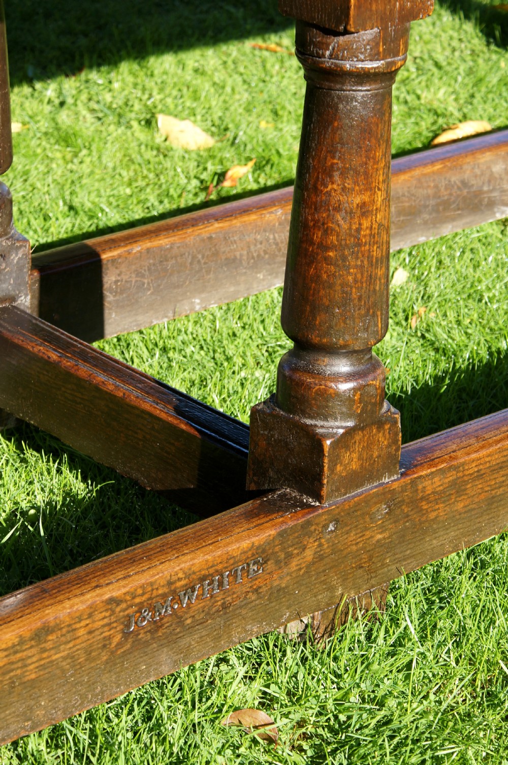 A large 17th-century oak refectory dining table with a long plank top, six turned legs, and robust perimeter stretchers. View X