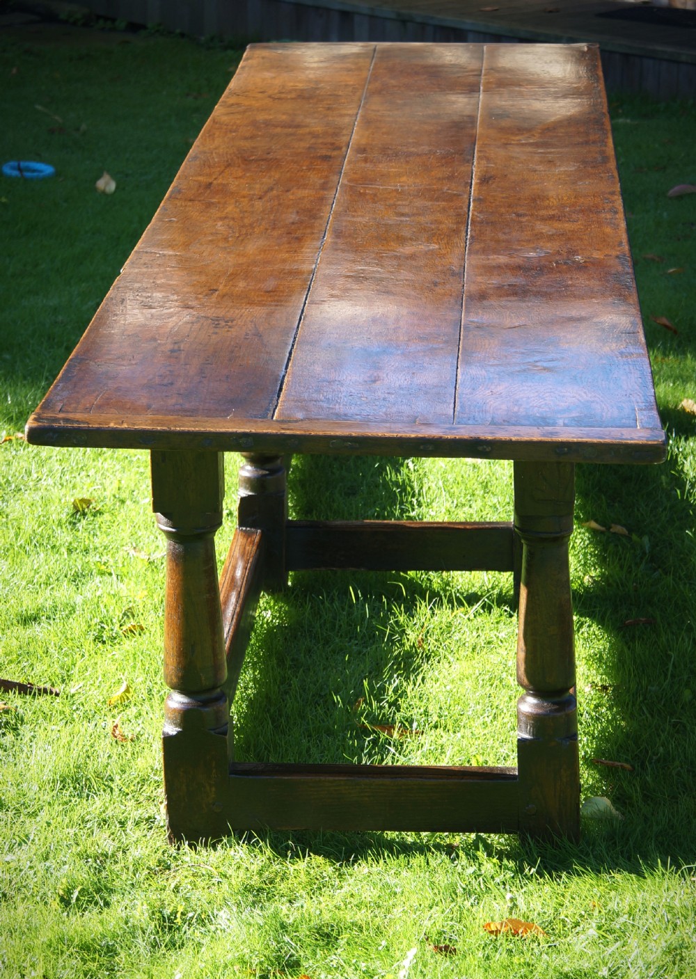 A large 17th-century oak refectory dining table with a long plank top, six turned legs, and robust perimeter stretchers. View XIV
