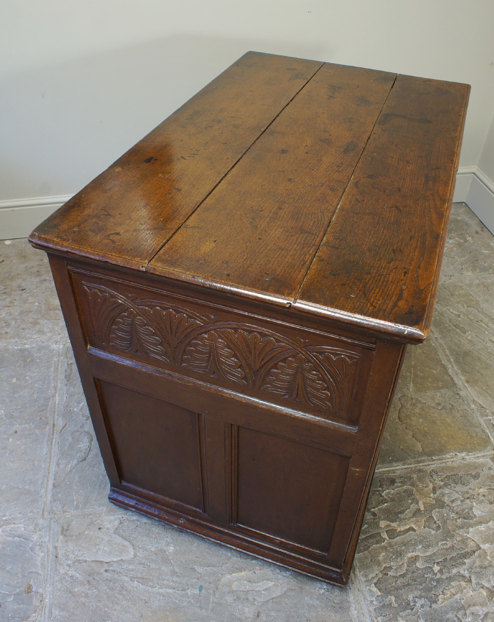 A seventeenth-century dark oak chest of drawers featuring geometric applied mouldings and brass teardrop handles. View XIII