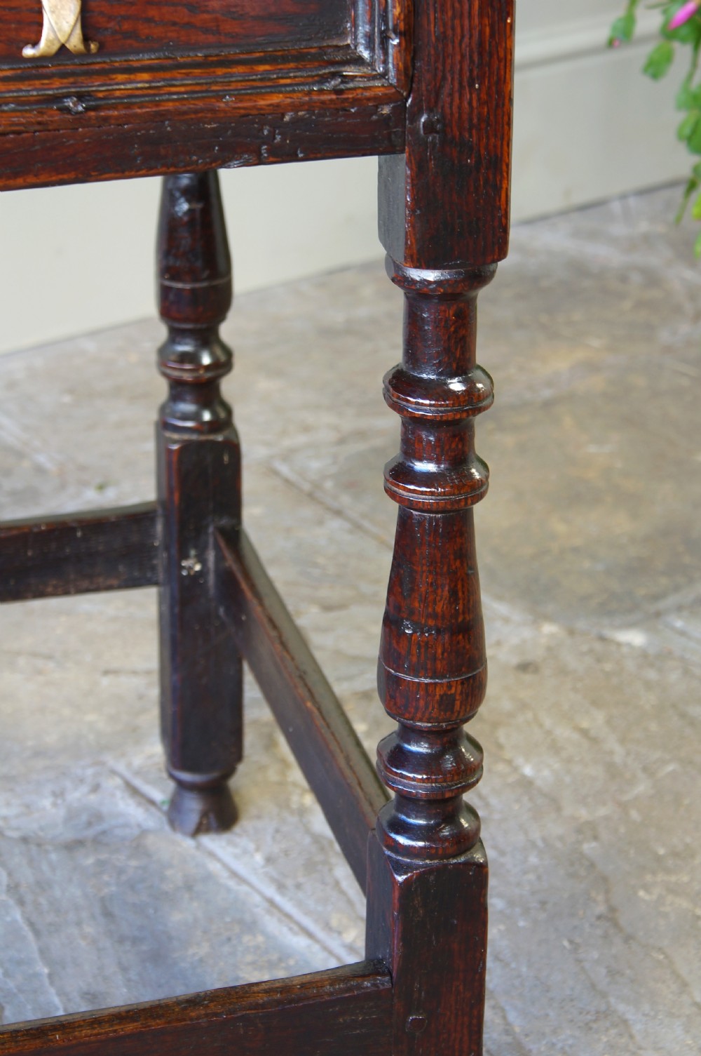 A late 17th-century dark oak side table featuring a single moulded drawer front, brass escutcheon, baluster-turned legs, and a perimeter box stretcher. View III