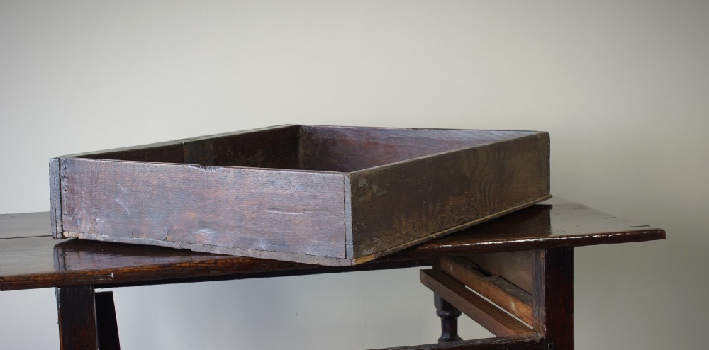 A late 17th-century dark oak side table featuring a single moulded drawer front, brass escutcheon, baluster-turned legs, and a perimeter box stretcher. View X