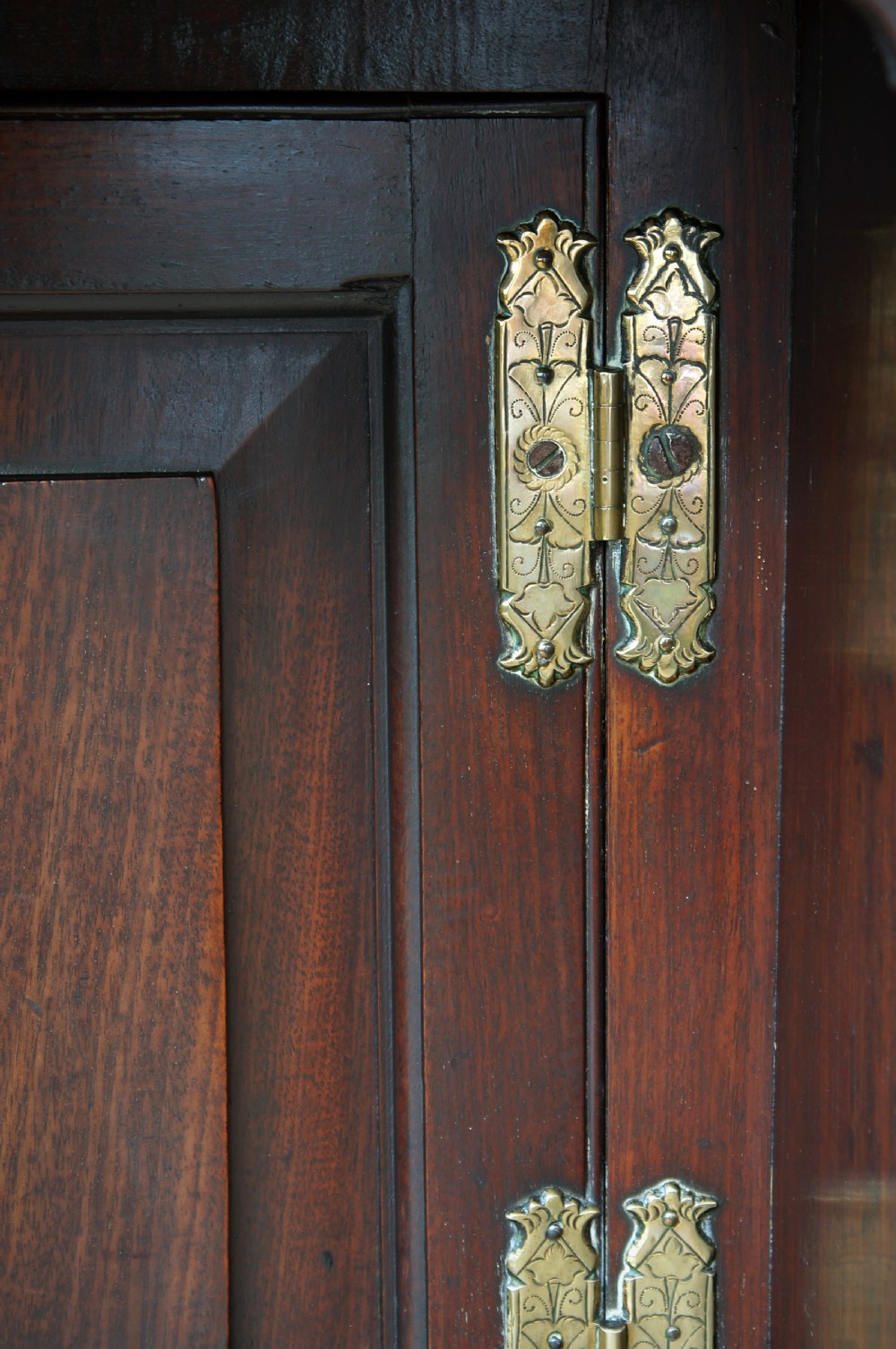 An early Georgian mahogany kneehole bureau featuring a slanted fall-front top lid, brass drop handles, multiple drawers, and a central recessed cupboard on bracket feet. View XVIII