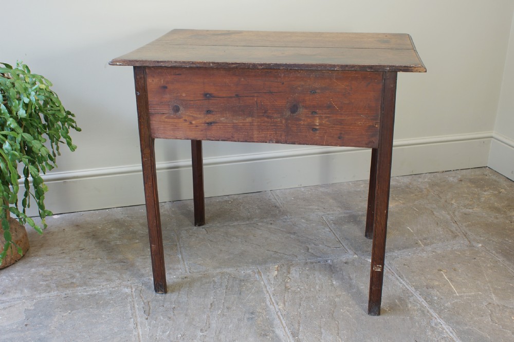 A George III oak lowboy side table featuring three drawers with brass swan-neck handles, a shaped apron, and four square legs. View V