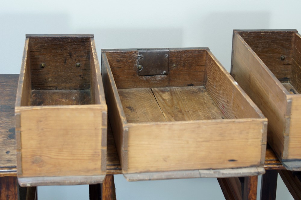 A George III oak lowboy side table featuring three drawers with brass swan-neck handles, a shaped apron, and four square legs. View VII