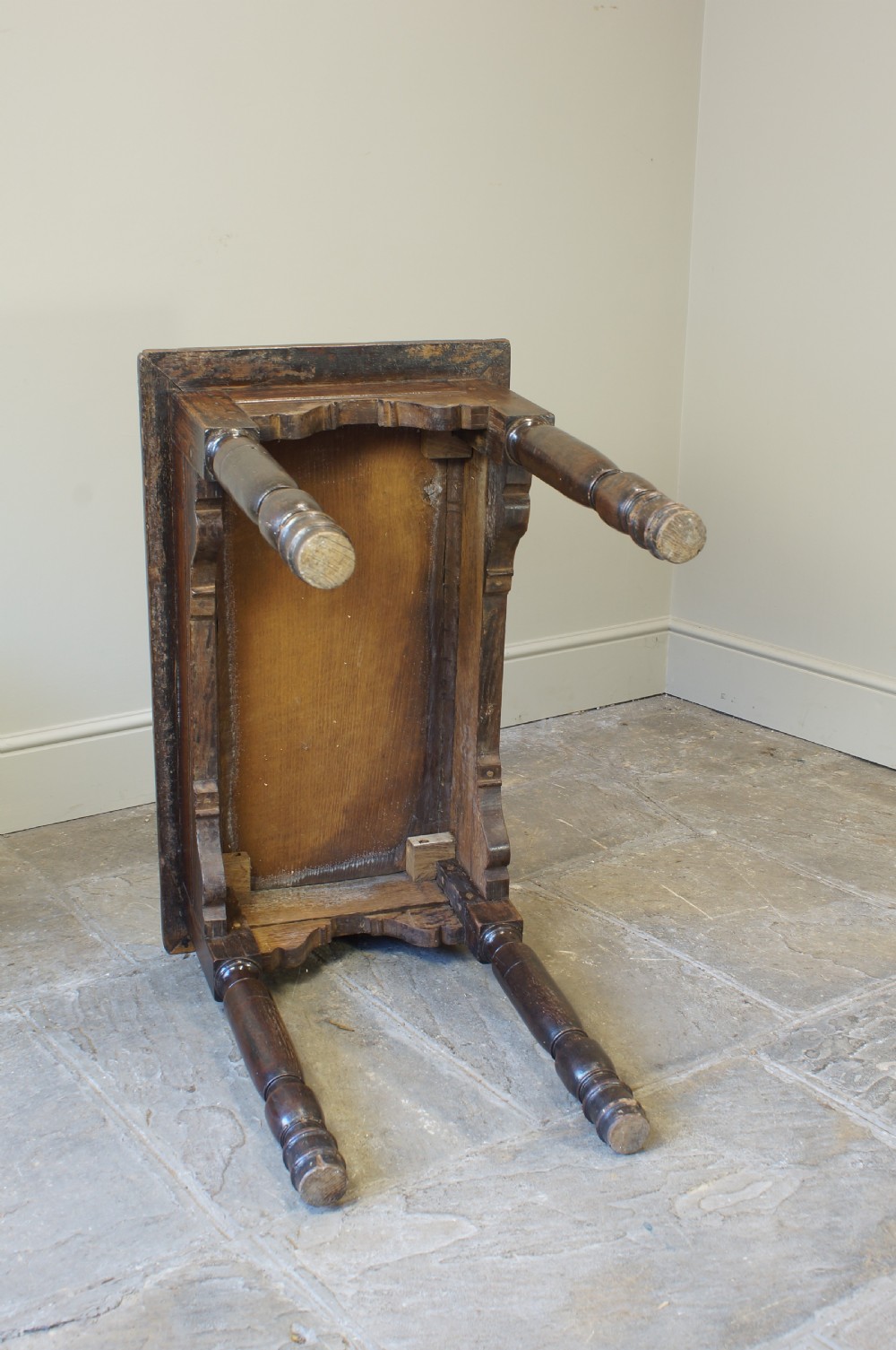 An early 17th century dark oak table with a framed rectangular top, turned legs, and pegged mortise and tenon joinery. View VI