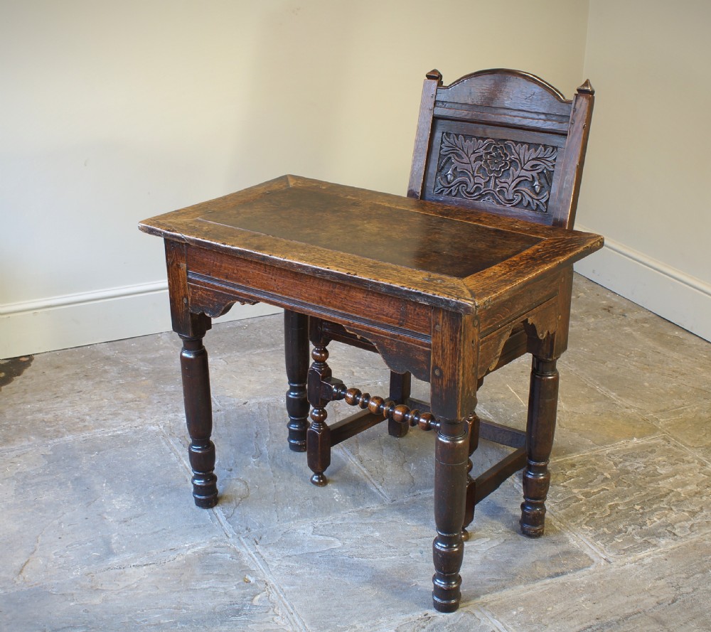 An early 17th century dark oak table with a framed rectangular top, turned legs, and pegged mortise and tenon joinery. View VIII