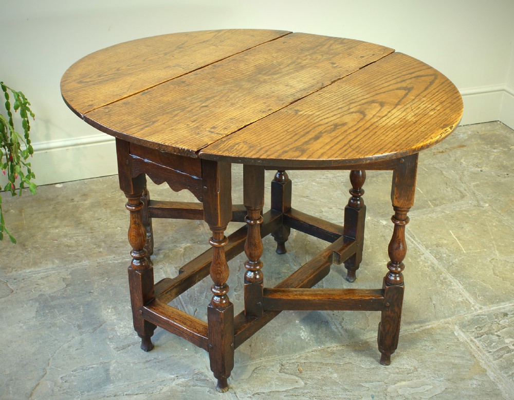 A small 17th-century oak gateleg table with two drop leaves, turned legs, and lower box stretchers. View II
