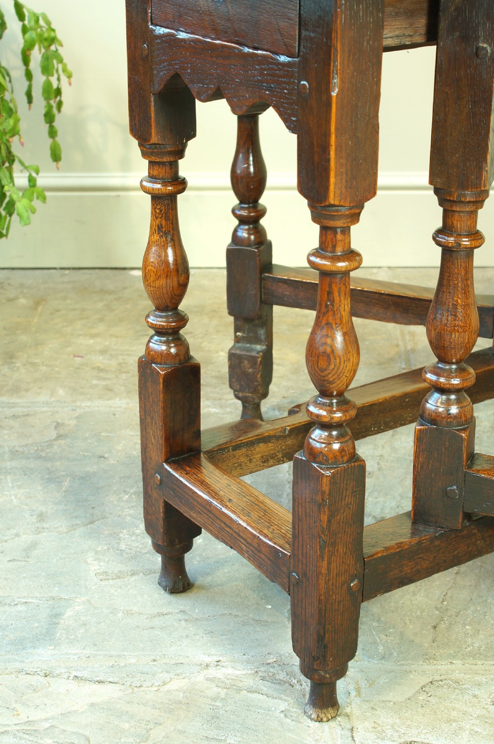 A small 17th-century oak gateleg table with two drop leaves, turned legs, and lower box stretchers. View XII