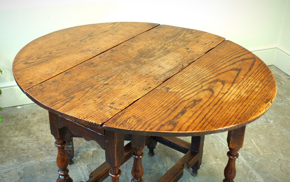 A small 17th-century oak gateleg table with two drop leaves, turned legs, and lower box stretchers. View XIII