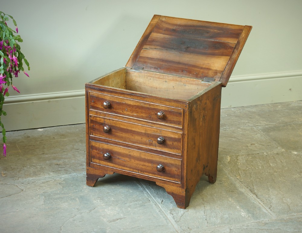 A Georgian plumwood close stool disguised as a small three-drawer chest with turned wooden knobs and bracket feet. View VIII