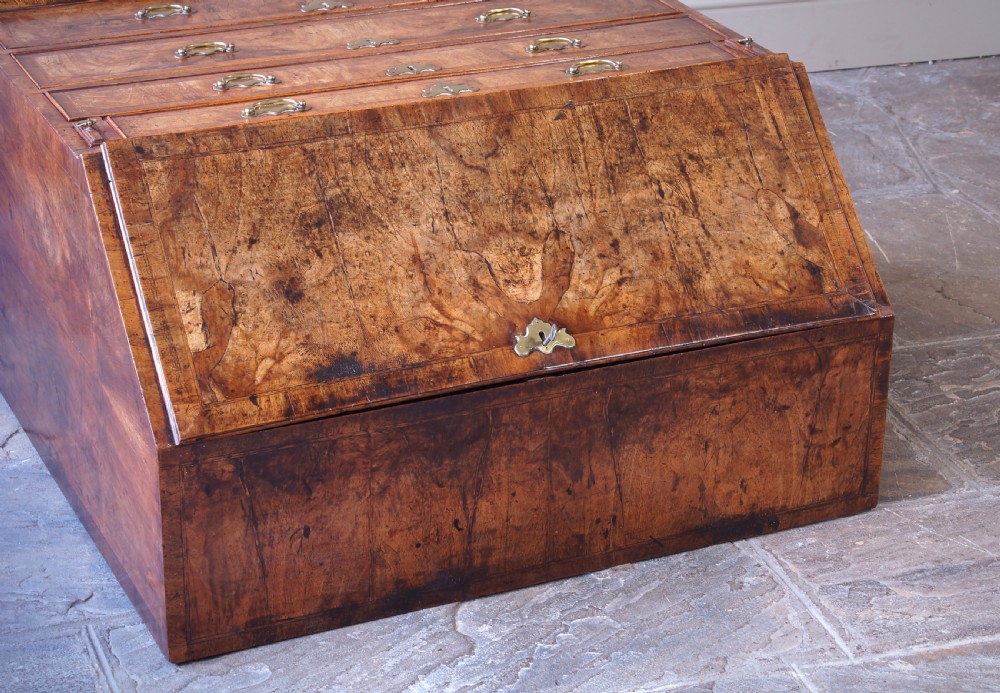 An 18th-century George II walnut bureau featuring a slant-front lid above four graduated drawers with brass handles, supported by bracket feet. View XI