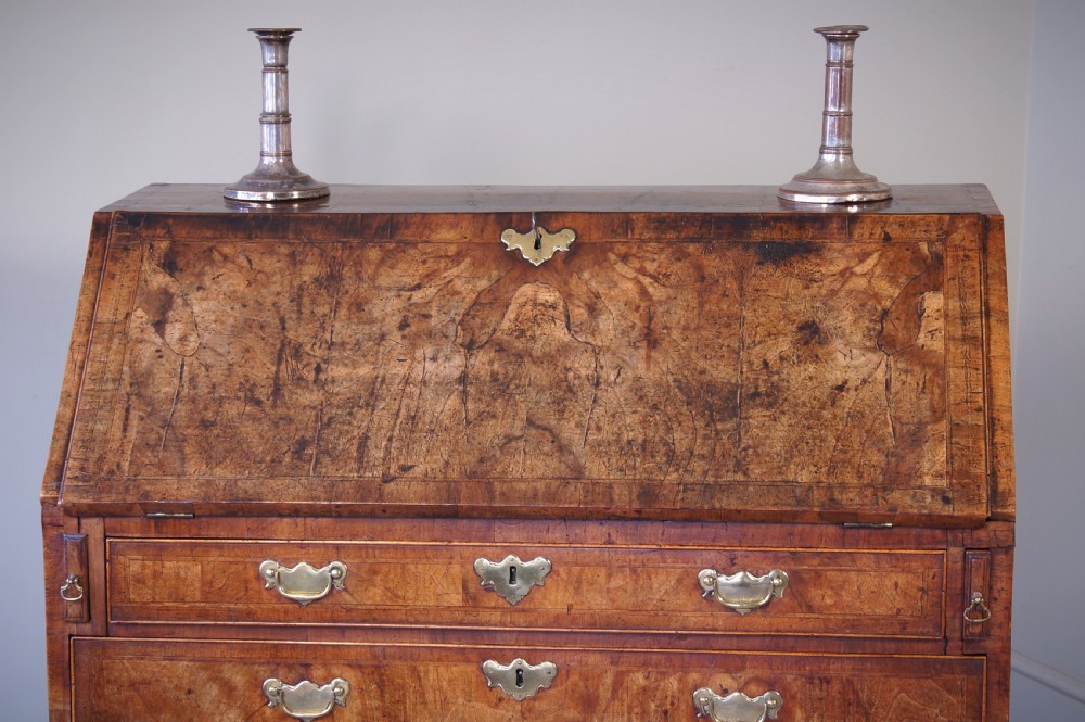 An 18th-century George II walnut bureau featuring a slant-front lid above four graduated drawers with brass handles, supported by bracket feet. View XIII