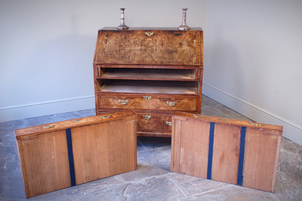 An 18th-century George II walnut bureau featuring a slant-front lid above four graduated drawers with brass handles, supported by bracket feet. View XIV