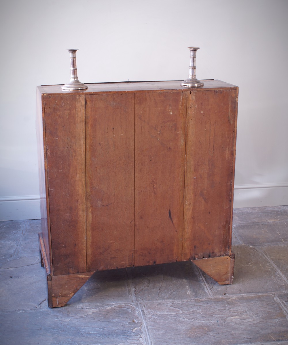 An 18th-century George II walnut bureau featuring a slant-front lid above four graduated drawers with brass handles, supported by bracket feet. View XV