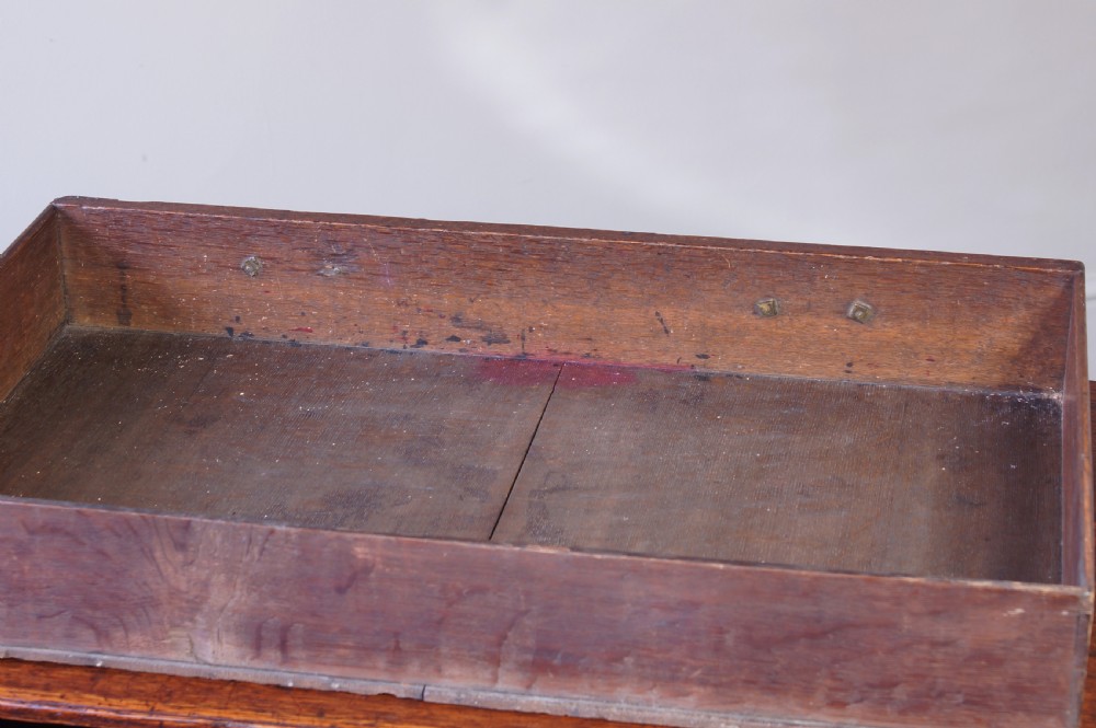 An 18th-century oak lowboy side table featuring cabriole legs, multiple drawers with brass swing handles, and an arched apron detail. View IV